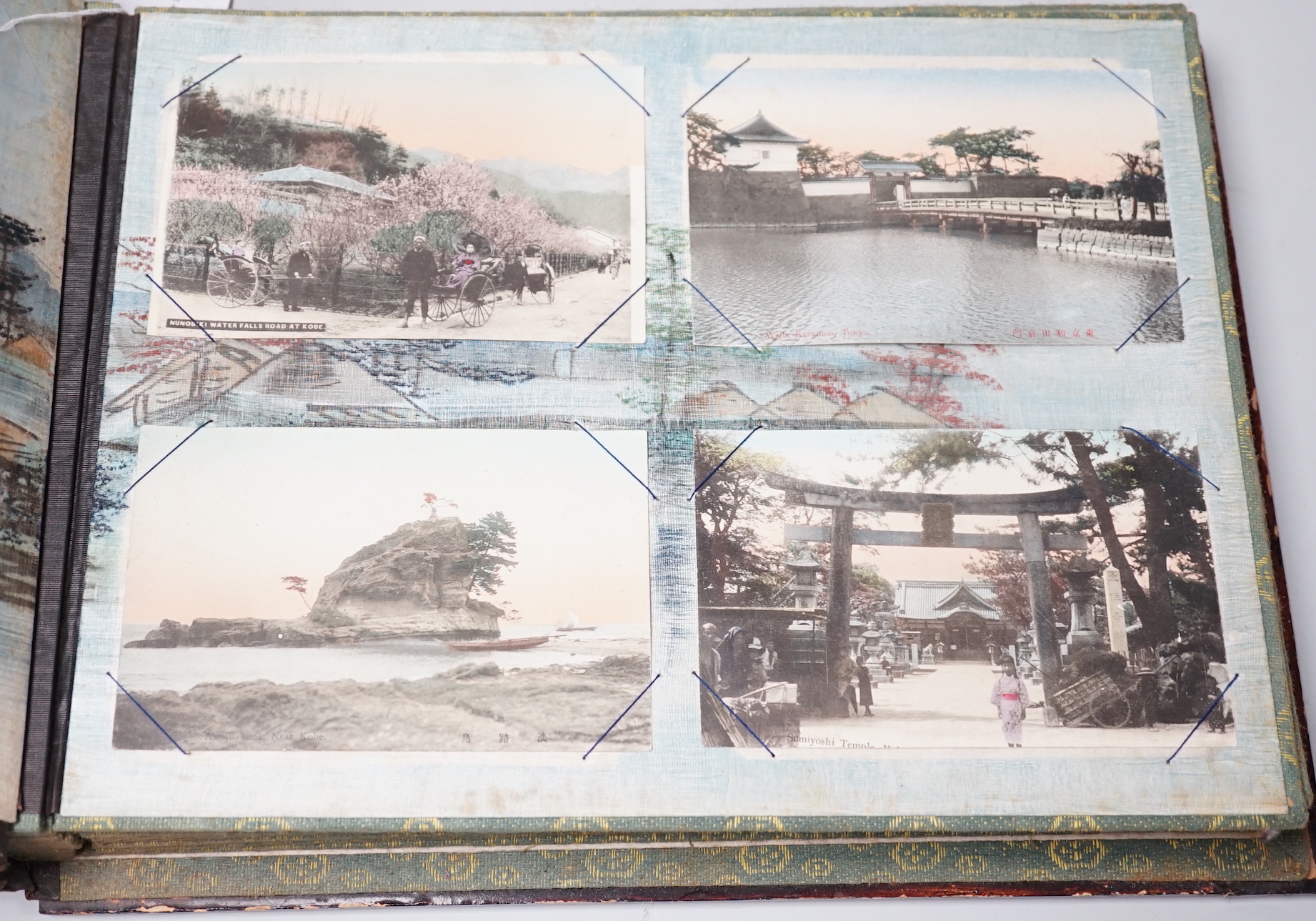 A Japanese photo album with handcoloured postcards of Japan, Ceylon, India etc.